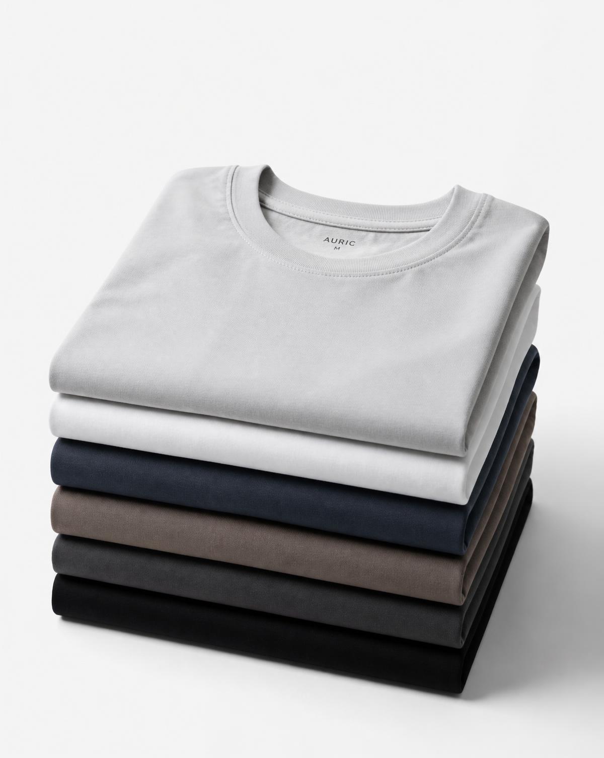 Stack of plain cotton t-shirts in neutral colours